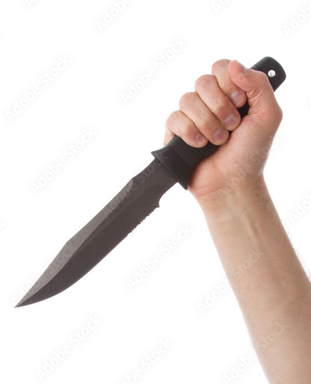 A hand gripping a serrated black knife, held up as if to strike